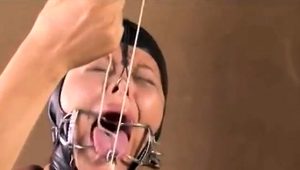  Helpless Asian slut with big boobs takes a fist in her peach